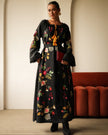 Full-length view of black floral embroidered linen kaftan maxi dress styled with black ankle boots and red clutch — Zalxndra Resort