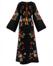 Black embroidered linen kaftan maxi dress with multi-color floral motif and mustard tassel ties shown on white background — Zalxndra Resort