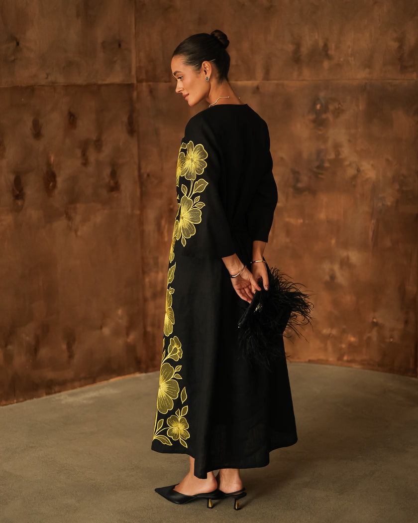 Back view of black linen kaftan maxi dress with bold gold floral embroidery and flared sleeves - Zalxndra Resort