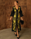 Black linen kaftan maxi dress with bold gold floral embroidery, V-neck, flared sleeves, and front slit styled with feather clutch - Zalxndra Resort