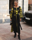 Black linen kaftan maxi dress with gold geometric embroidery, balloon sleeves and gold tassel ties, styled with black handbag and boots, full length view - Zalxndra Resort