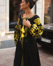 Black linen kaftan maxi dress with gold geometric embroidery, balloon sleeves and gold tassel ties, side profile view - Zalxndra Resort