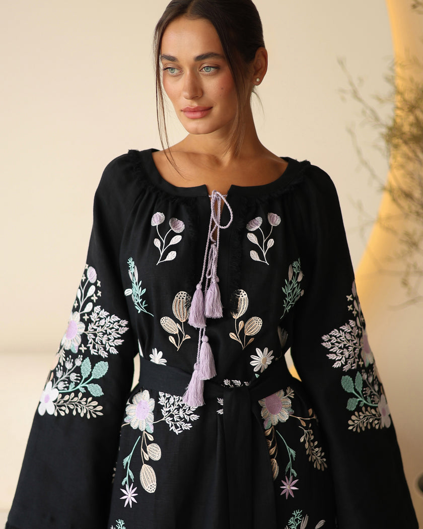 Bodice detail of black linen kaftan maxi dress with pastel floral embroidery and lilac tassel ties - Zalxndra Resort
