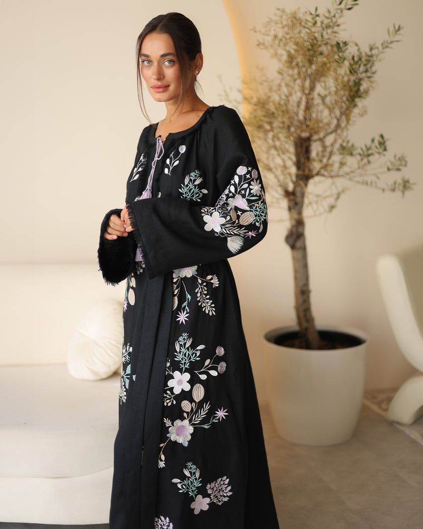 Black linen kaftan maxi dress with pastel floral embroidery and lilac tassel ties styled portrait - Zalxndra Resort