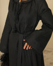 Close-up of tonal black floral embroidery and tassel ties on linen kaftan maxi dress - Zalxndra Resort