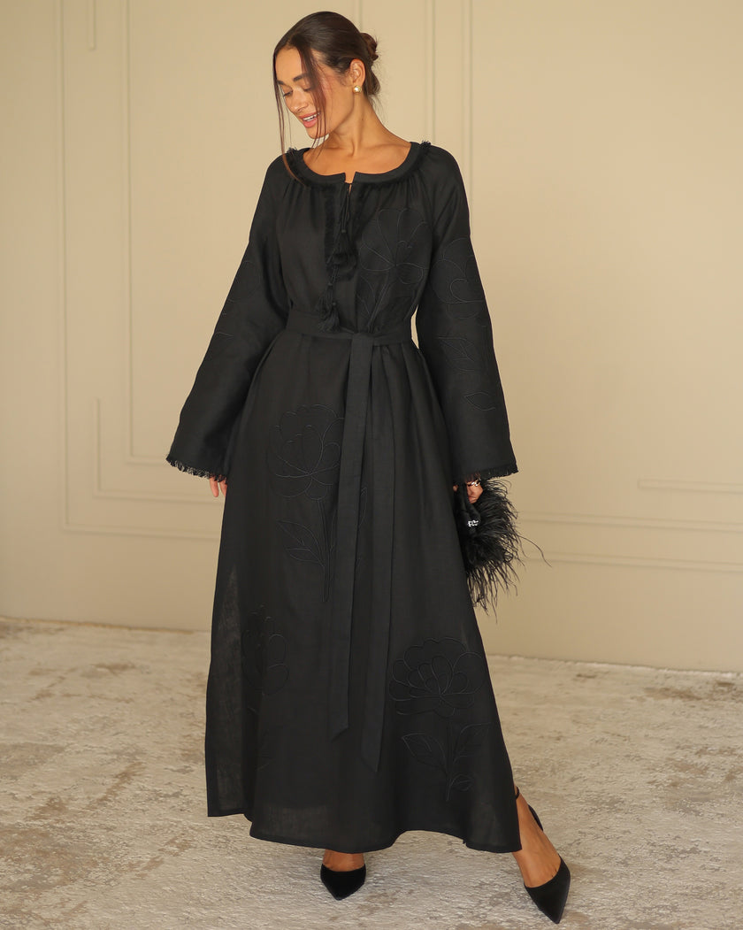 Full-length view of black linen kaftan maxi dress with tonal floral embroidery, frayed bell sleeves, and tassel ties - Zalxndra Resort
