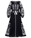 Black linen kaftan maxi dress with white geometric embroidery, balloon sleeves, tassel ties and self-tie belt, full-length view - Zalxndra Resort