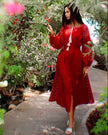 Cherry red linen kaftan maxi dress with white embroidery, balloon sleeves and tassel ties, garden editorial view - Zalxndra Resort