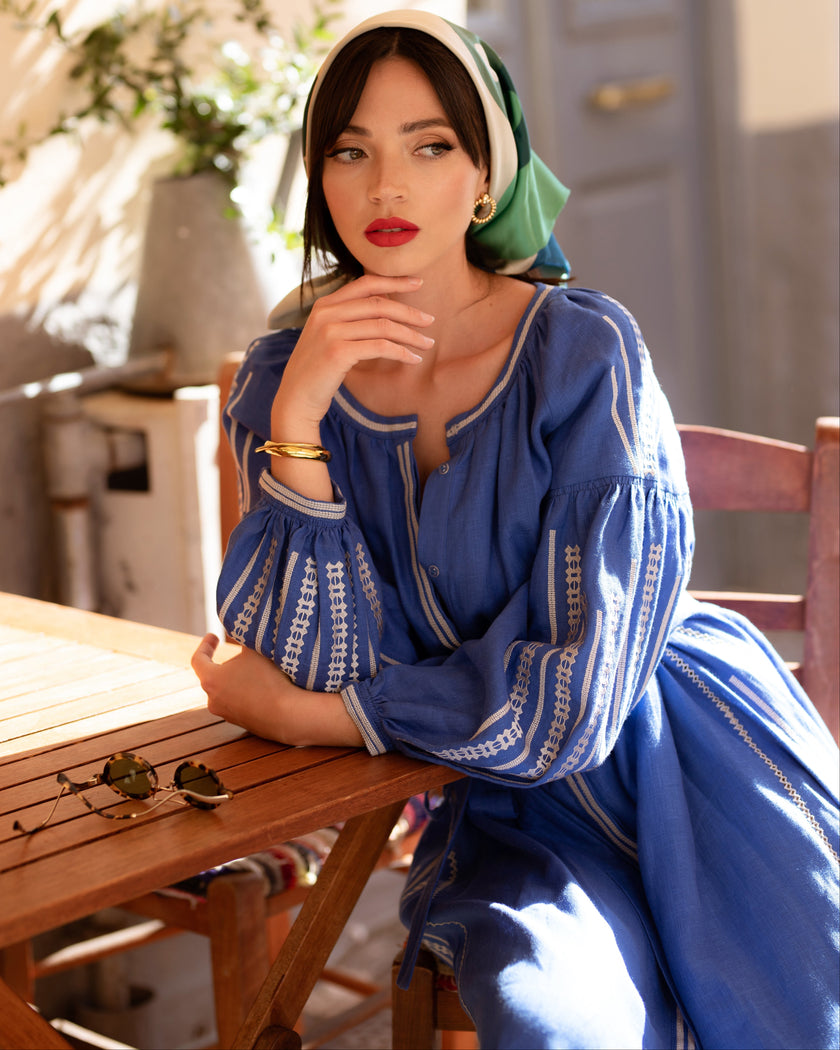 French blue linen kaftan maxi dress with white embroidery and balloon sleeves, styled with green silk headscarf, portrait view - Zalxndra Resort