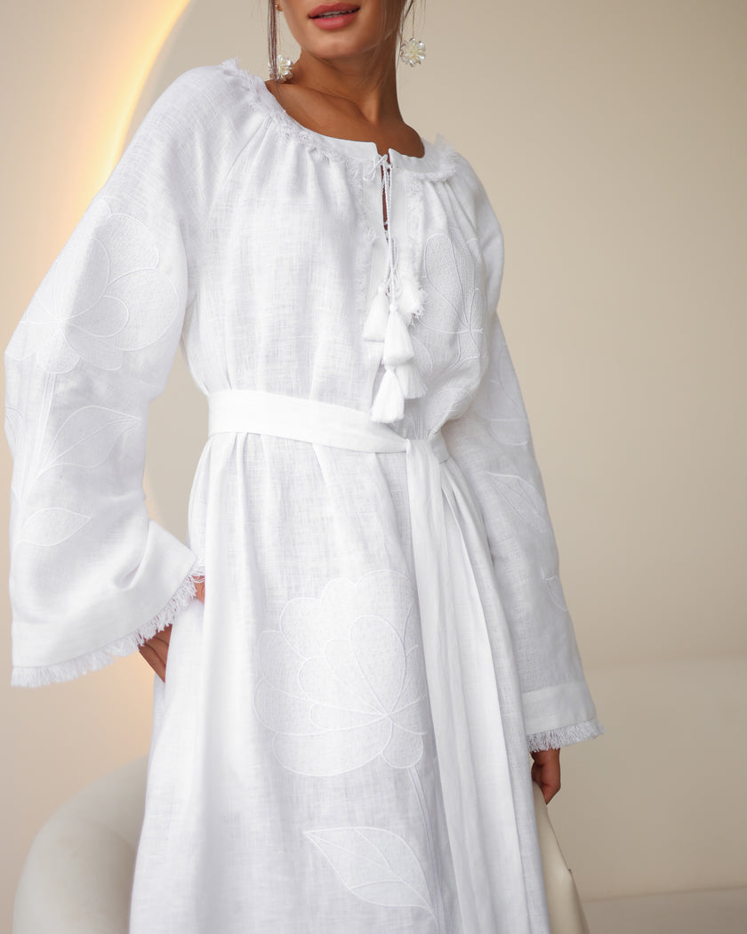 Sleeve and bodice detail of white linen kaftan maxi dress with tonal floral embroidery, frayed bell sleeves, and tassel ties - Zalxndra Resort
