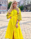 Lemon yellow linen kaftan maxi dress with black floral embroidery, balloon sleeves and self-tie belt, styled outdoor view - Zalxndra Resort