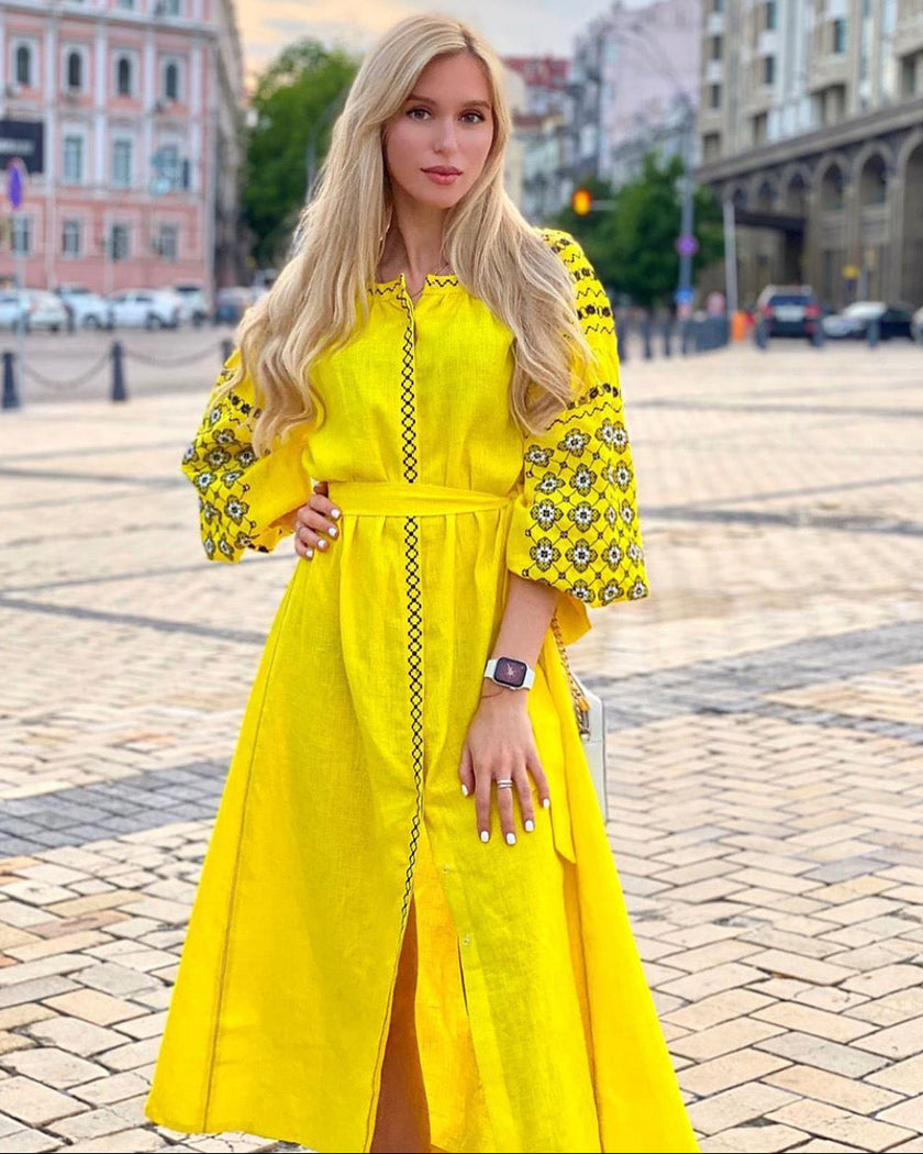 Lemon yellow linen kaftan maxi dress with black floral embroidery, balloon sleeves and self-tie belt, styled outdoor view - Zalxndra Resort