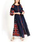 Navy blue linen kaftan maxi dress with red, orange, and white hand-embroidered cross-stitch geometric pattern, balloon sleeves, and self-tie belt on model, full-length view - Zalxndra Resort