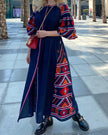 Navy blue linen kaftan maxi dress with red and orange hand-embroidered cross-stitch, balloon sleeves, and self-tie belt, styled on city street - Zalxndra Resort