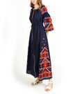 Navy blue linen kaftan maxi dress with red, orange, and white hand-embroidered cross-stitch, balloon sleeves, and self-tie belt, side view - Zalxndra Resort