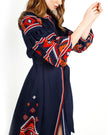Navy blue linen kaftan maxi dress with red, orange, and white hand-embroidered cross-stitch geometric pattern on balloon sleeves, sleeve detail - Zalxndra Resort