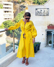 Saffron yellow linen kaftan maxi dress with navy geometric embroidery, balloon sleeves and tassel tie belt, styled on balcony, portrait view - Zalxndra Resort