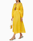 Saffron yellow linen kaftan maxi dress with navy geometric embroidery, balloon sleeves, tassel tie and self-tie belt, styled with cream shoulder bag - Zalxndra Resort