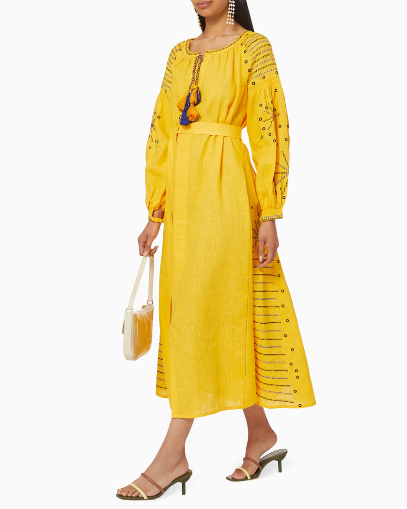 Saffron yellow linen kaftan maxi dress with navy geometric embroidery, balloon sleeves, tassel tie and self-tie belt, styled with cream shoulder bag - Zalxndra Resort