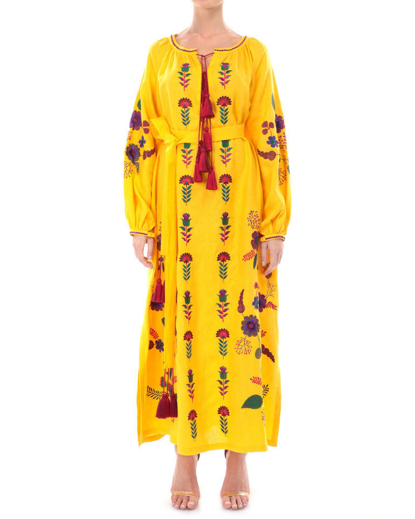 Saffron yellow linen kaftan maxi dress with multicolour floral embroidery, balloon sleeves, self-tie belt, and tassel ties on model, full-length view - Zalxndra Resort