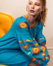 Model in turquoise linen kaftan midi dress with orange and yellow geometric embroidery and balloon sleeves - Zalxndra Resort