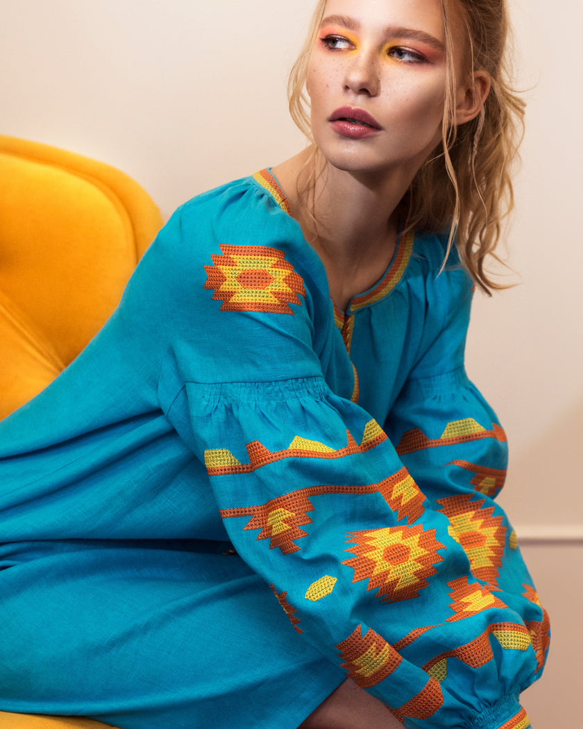 Model in turquoise linen kaftan midi dress with orange and yellow geometric embroidery and balloon sleeves - Zalxndra Resort