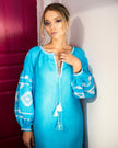 Portrait of model in turquoise linen kaftan midi dress with white geometric embroidery and tassel ties - Zalxndra Resort