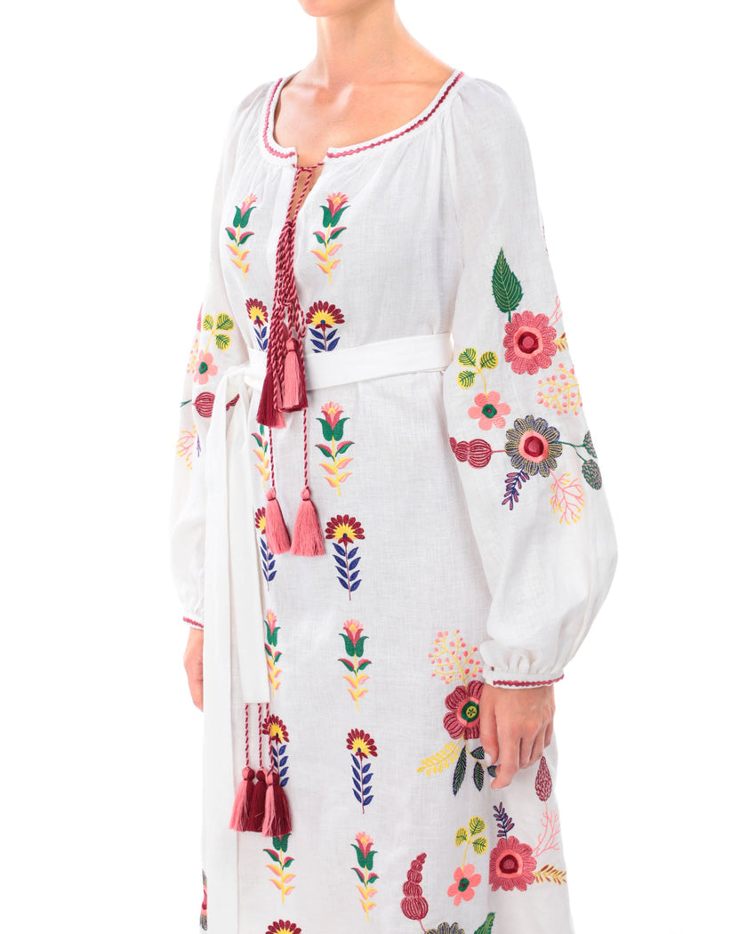 White linen kaftan maxi dress with multicolour folk floral embroidery on bodice and balloon sleeves, self-tie belt with tassel ties, bodice detail - Zalxndra Resort