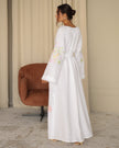 Back view of white pastel floral embroidered linen kaftan maxi dress with flared sleeves — Zalxndra Resort