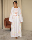 Catalog front view of white pastel floral embroidered linen kaftan maxi dress with self-tie belt — Zalxndra Resort