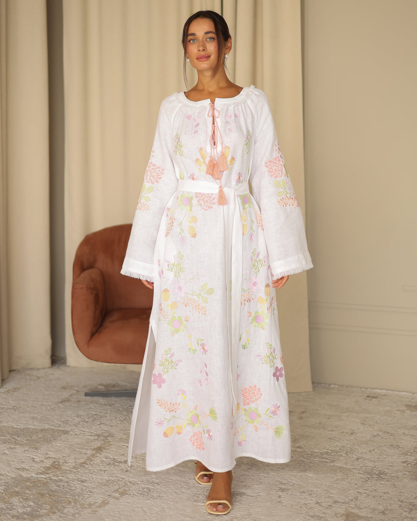 Full-length view of white pastel floral embroidered linen kaftan maxi dress styled with leather sandals — Zalxndra Resort