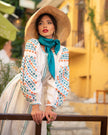 White linen maxi dress with teal and orange geometric embroidery, balloon sleeves, styled with straw hat and teal silk scarf - Zalxndra Resort