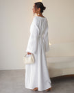 Back view of white linen kaftan maxi dress with tonal floral embroidery and frayed bell sleeves - Zalxndra Resort