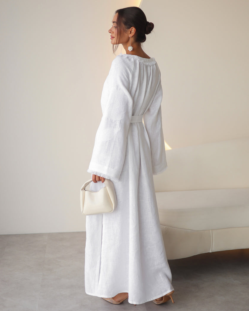 Back view of white linen kaftan maxi dress with tonal floral embroidery and frayed bell sleeves - Zalxndra Resort