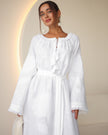 Portrait view of white linen kaftan maxi dress with tonal floral embroidery, frayed bell sleeves, and tassel ties - Zalxndra Resort