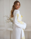 Sleeve detail of white linen kaftan maxi dress with yellow floral embroidery and frayed angel sleeve - Zalxndra Resort