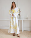 White linen kaftan maxi dress with yellow floral embroidery, angel sleeves, and tassel tie styled portrait - Zalxndra Resort