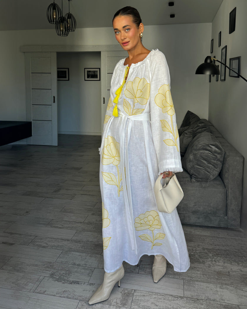 Full-length view of white linen kaftan maxi dress with yellow outlined floral embroidery, angel sleeves, and tassel tie - Zalxndra Resort