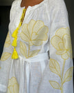 Sleeve detail of white linen kaftan maxi dress with yellow outlined floral embroidery, frayed angel sleeves, and tassel ties - Zalxndra Resort