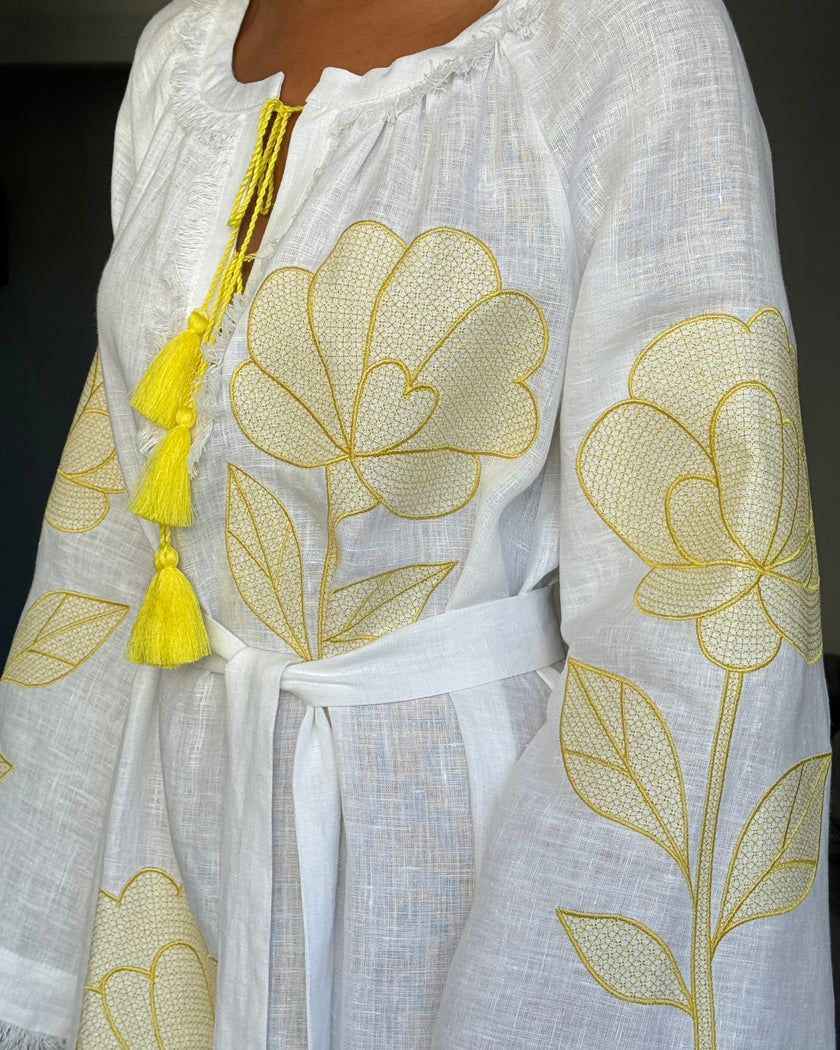Sleeve detail of white linen kaftan maxi dress with yellow outlined floral embroidery, frayed angel sleeves, and tassel ties - Zalxndra Resort